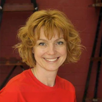 Dentist Tetyana Shreyer Smiling In Bright Red Shirt